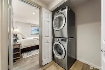 Behind sleek double doors, you'll discover the full-size stacked washer and dryer offer modern convenience—plus extra side space perfect for shelving or laundry essentials.