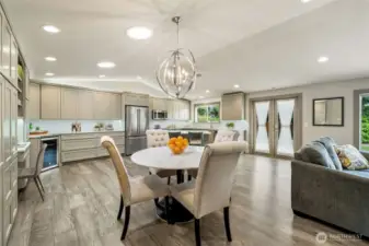 Bathed in natural light from abundant skylights, the open-concept living, dining, and kitchen areas create an inviting atmosphere. Don't miss the versatile desk nook, offering convenience and flexibility for both entertaining and daily tasks.