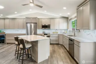 This chef’s kitchen features top-of-the-line GE Café appliances, elegant Quartzite countertops, and a sleek, modern backsplash that adds a polished touch. And here’s the fun part—grab a dry erase marker and leave a cheerful note or tonight’s menu right on the backsplash!