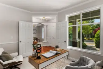 Just off the foyer, the den features classic French doors, a large front-facing window, and elegant chair rail detailing—making it an ideal spot for a home office with, if desired, the perfect setup to welcome clients. This flexible space also works beautifully as a reading room, study, or creative retreat.