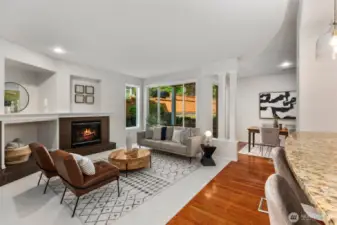 The open-concept layout creates a seamless connection to the kitchen, with a granite-topped breakfast bar perfect for casual dining or conversation. The space feels both connected and comfortable—ideal for gathering, entertaining, or quiet evenings at home.