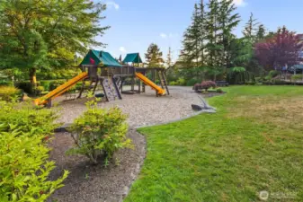Just across the cul-de-sac, a charming pocket park invites play and relaxation with its colorful playground, winding cement path, open lawn, picnic table, and mature trees—perfect for little ones, walking the dog, or enjoying a quiet picnic beneath the trees. A short walk away is another park, Woodlands park, with a walking trail entrance a short way west on NE 116th St and north on 171st Pl NE on the right side of the street, just a couple blocks away.