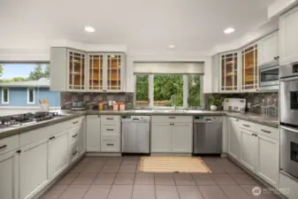 Kitchen with 2 washing machines (Bosch) , integrated double oven, gas cooktop (Bosch), telescopic downdraft with remote blower, integrated microwave oven, fridge with ice/water dispenser, additional beverage refrigerator.