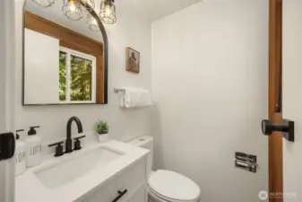 Freshly updated powder room off of the flex space