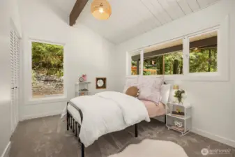 Freshly carpeted this charming room holds space for creativity and imagination with its charming porthole.