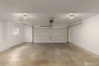 Spacious attached 2-car garage with additional storage space