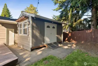 The 10x16 sqft workshop/shed includes power, benches and cabinets!
