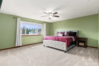Large primary bedroom with tons of natural lighting
