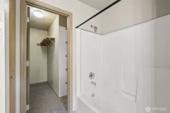 Primary bath leading to spacious walk-in closet
