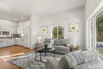 Beautiful great room living area, including vaulted ceilings, white painted millwork, and newly refinished hardwoods.