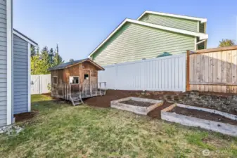 Raised beds plus an adorable play house.
