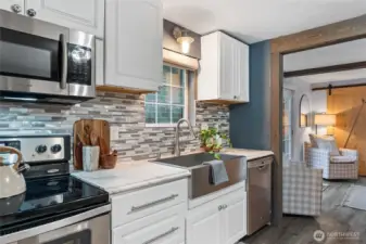 Inviting kitchen perfect for gatherings, with stainless steel appliances.