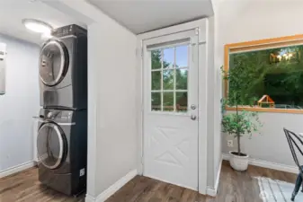 Laundry area with stackable washer and dryer that stay with the home.
