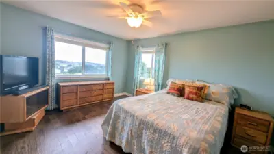 Primary bedroom with ocean views and ensuite bathroom and walk-in closet