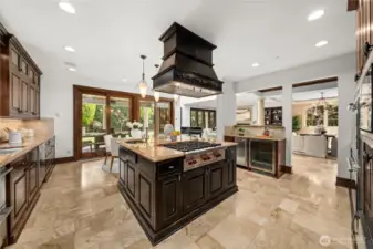 Chef’s kitchen with oversized island, premium appliances, and seamless connection to dining and living spaces.