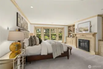 Elegant primary suite featuring a fireplace, custom built-ins, and French doors to a private balcony retreat