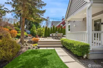 Just outside the laundry room is a sweet covered porch leading to manicured gardens and French Oak composite desks extending the living spaces out doors with a private hot tub to the right.