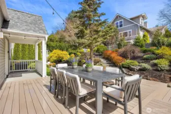 Above the outside dining deck are steps leading to an upper level garden area.