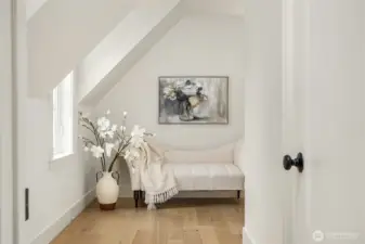A sweet dressing room in the Primary Suite with adjacent walk-in closet and bath to the right.