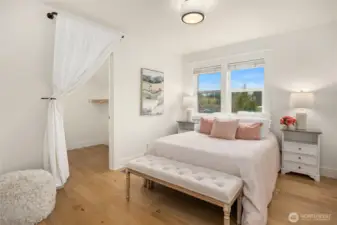 Across the hall from the full bath is a lovely bedroom with walk-in closet, and more of the warm oak flooring.