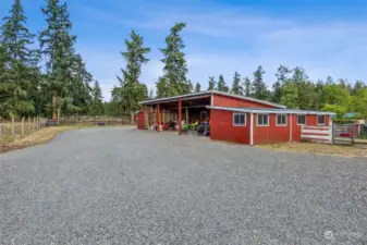 The covered parking portion of this outbuilding is 44'x27'. There is a barn enclosure at each end, measuring roughly 12'x27'. Please see the attached listing supplements and/or 3D tour for additional details and photos.