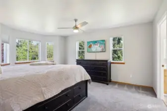 Beautiful primary bedroom with views of the backyard and lots of natural bright lighting!