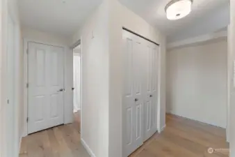 This view shows the transition from the pantry closet to the hallway where the bathroom and bedroom are