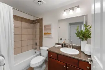 Full sized tub/shower combo with large vanity/mirror