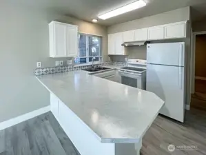 Unit A kitchen with breakfast bar.
