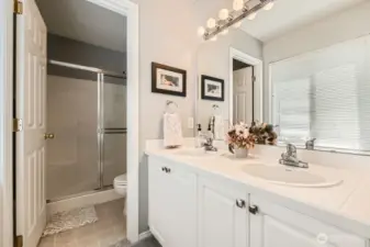 Separate vanity area allows for a multi tasking bathroom.