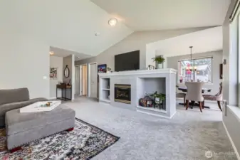 The living room is central to the condo with the dining room, kitchen & deck on one side, and bedrooms on the other.