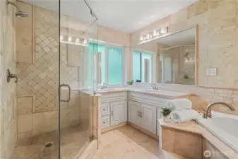 Spacious ensuite with dual vanities, walk-in shower, soaking tub, and private water closet.