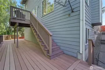 Deck off main living area to lower level deck and fenced yard.