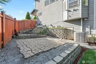 Additional seating or firepit area with pavers.