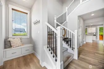 Foyer with bench and beautiful open staircase