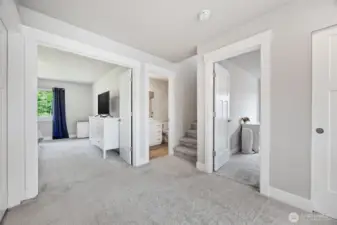 Upstairs hall way, primary bedroom thru French doors