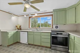 Country kitchen w/ freshly painted cabinets.