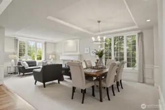 Formal living and dining rooms with wainscoting and crown molding.