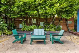 The fully fenced back yard has multiple gathering areas.