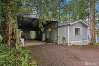 Huge Industrial Carport next to the back of the house.  Back door opens to the carport.