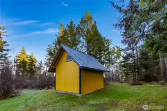 View northeast showing attractive tractor/equipment outbuilding.   This location of the property sits at approximately 280' of elevation.