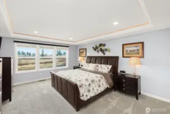 Generously sized primary suite with the privacy of sweeping views of the wetlands behind.  Coved ceiling with recessed lighting creates a perfect space!