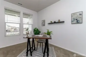 Spacious den overlooks the front covered porch and has another entry door to a full bathroom.