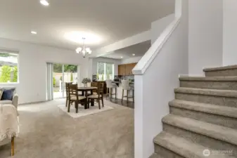 As you come through the entry and pass the den and full bath it opens to the staircase on the right and leads to the livingroom, dining room and kitchen.