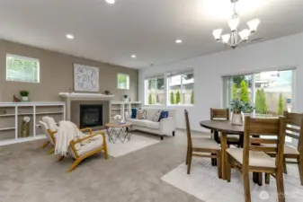 Living room with gas fireplace and built ins. Lots of natural light through these spacious windows and sliding glass doors. The dining room is just off the kitchen island.