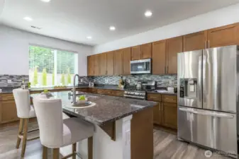 Stunning kitchen with an abundance of cabinets, storage and countertops.