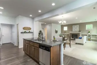 Kitchen island opens to the dining and family rooms. The door at the end of the hall opens to the two car garage.