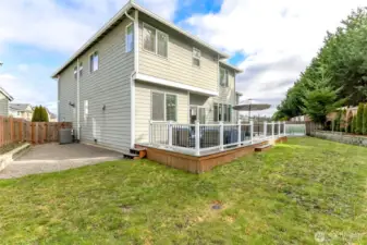 Central Air Conditioning and gravel area with retaining wall holding  fruit tree, strawberry plants and succulents.