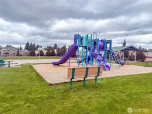 Community park a little over a block away. Covered picnic area, play toy and basketball court. Additional picnic table and several benches.