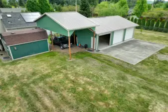 Three large bays, plus an RV carport - with a metal roof.